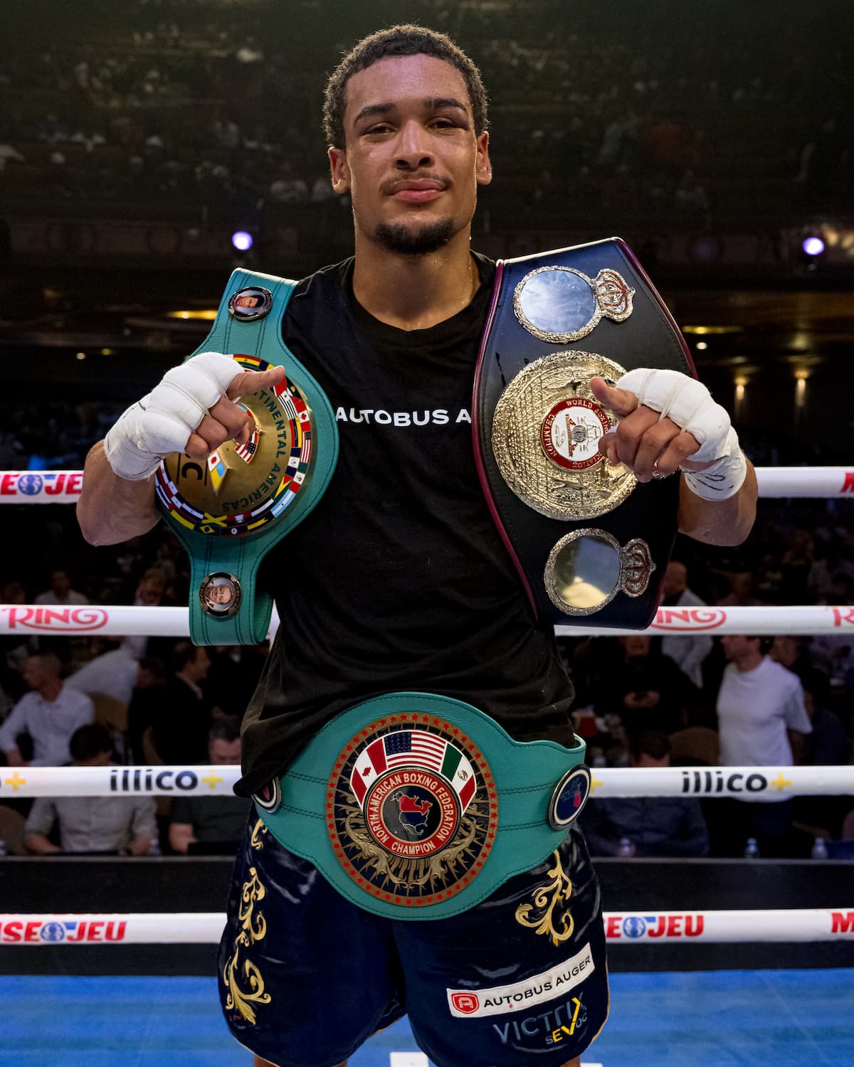Wilkens Mathieu poses with his championship belts following his victory over Vladimir Shishkin
