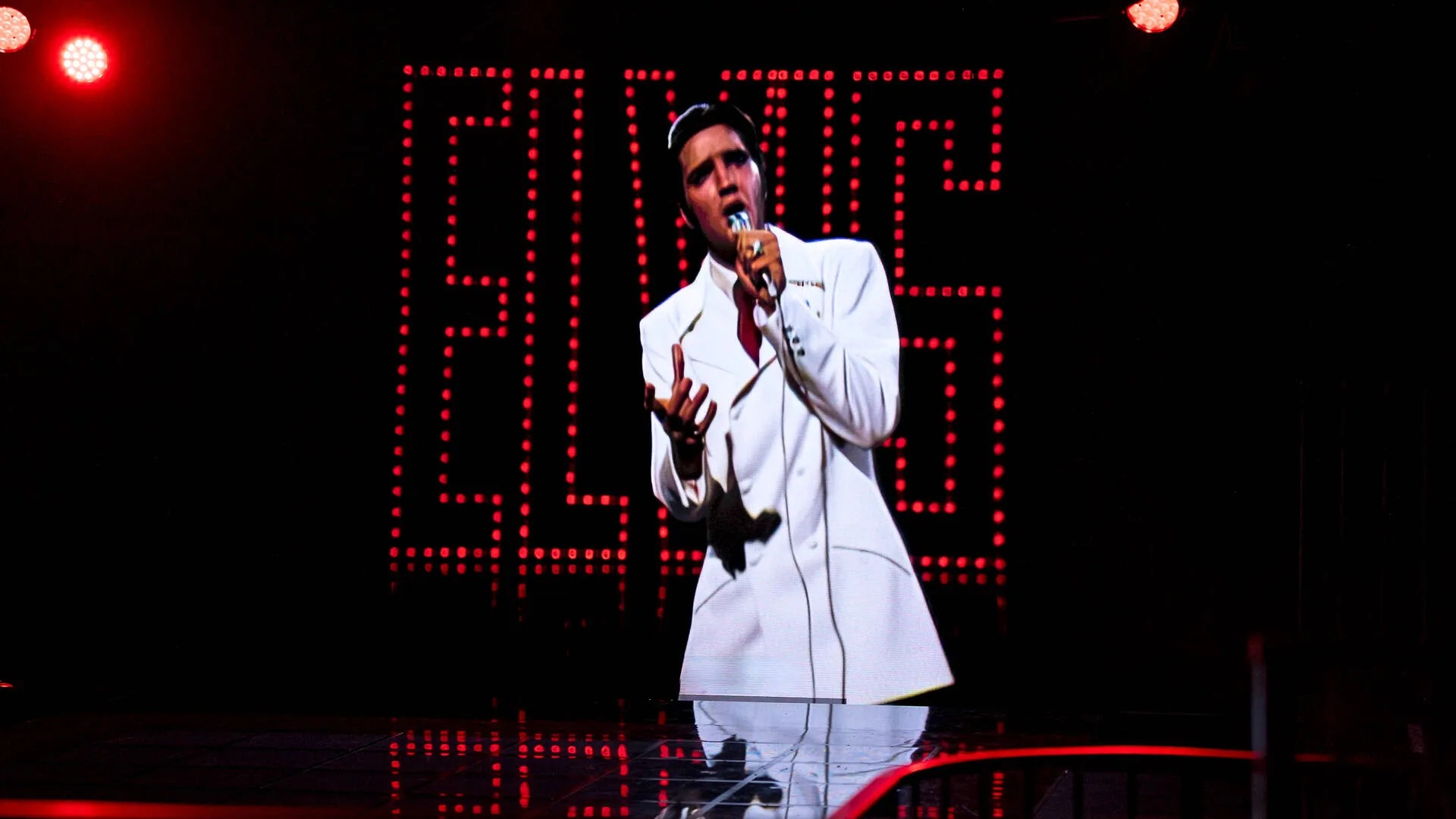 Elvis impersonator performing on stage.