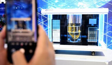 A visitor takes photos of an Origin Wukong superconducting quantum computer model at the 2024 World Manufacturing Convention in Hefei, east China