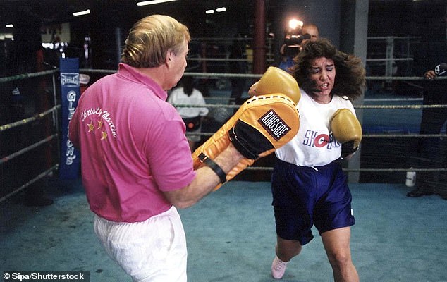 Christy, 56, originally from West Virginia , is credited with putting women's boxing on the map after taking on Deirdre Gogarty in front of a sell-out crowd at the MGM Grand in Las Vegas in 1996 - pictured with Jim in 1996