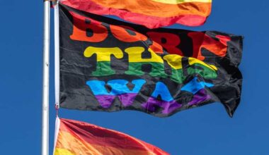 A booth selling pride flags flies a stack of flags with one that has “Born This Way” printed on it. The Eugene Pride Festival took place at Alton Baker Park in Eugene, Ore. on Saturday, Aug. 12th, 2023. (Molly McPherson/Emerald)