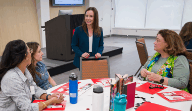 Annie Murray stands by table at the Employer Summit