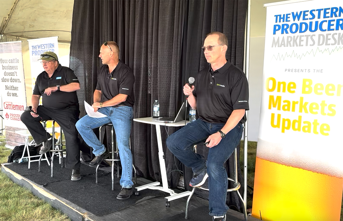 Left to right: Bruce Burnett, Jerry Klassen and Ranulf Glanville talk markets at the Ag in Motion farm show near Langham, Sask.