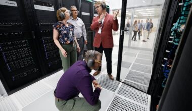 Michael Borda, the associate vice provost for Research and the executive director of Strategic Initiatives, takes a closer look at Betty, the University of Pennsylvania's new supercomputer in Collegeville, as Marylyn Ritchie (rear left), vice dean of Artificial Intelligence and Computing at the Perelman School of Medicine, and Jaime Combariza, executive director of the Penn Advanced Research Computing Center, listen to Kenneth Chaney, the center's associate director of AI and Technology.