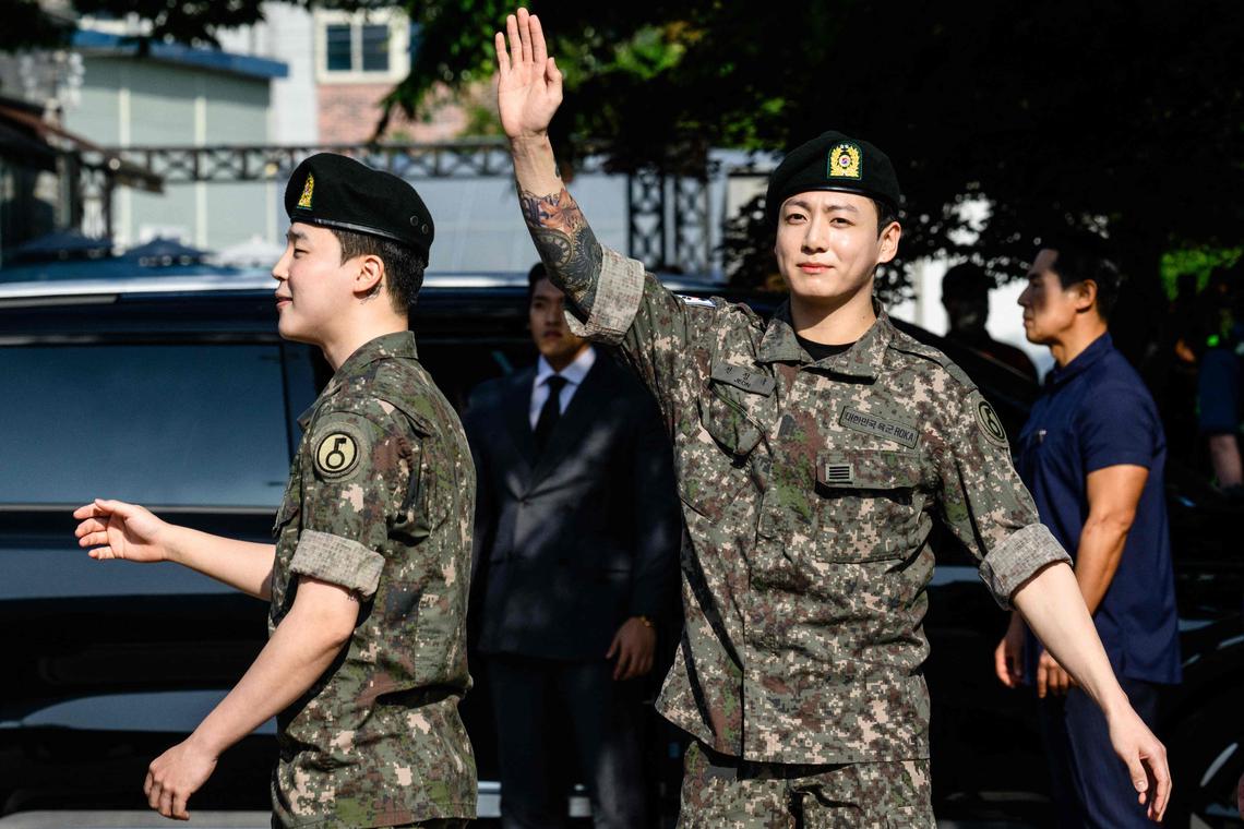 Jungkook of K-pop supergroup BTS waves as he departs from an outdoor sporting facility in Yeoncheon on June 11, 2025, shortly after his release from 18 months of South Korean military service.