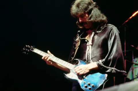 Getty Images Tony Iommi plays guitar