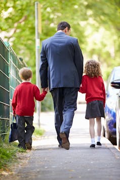 Father walking children to school