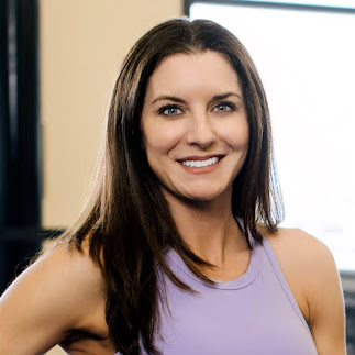 Headshot of smiling woman with brown hair wearing purple tank top