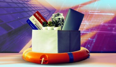 box on a life raft full of layoff items like plants, keyboard, money and health plan