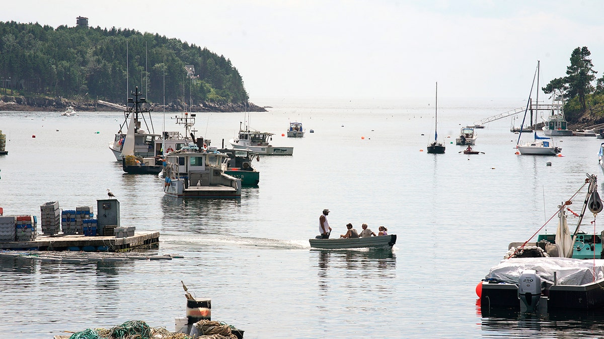People cross Mackerel Cove on Bailey Island