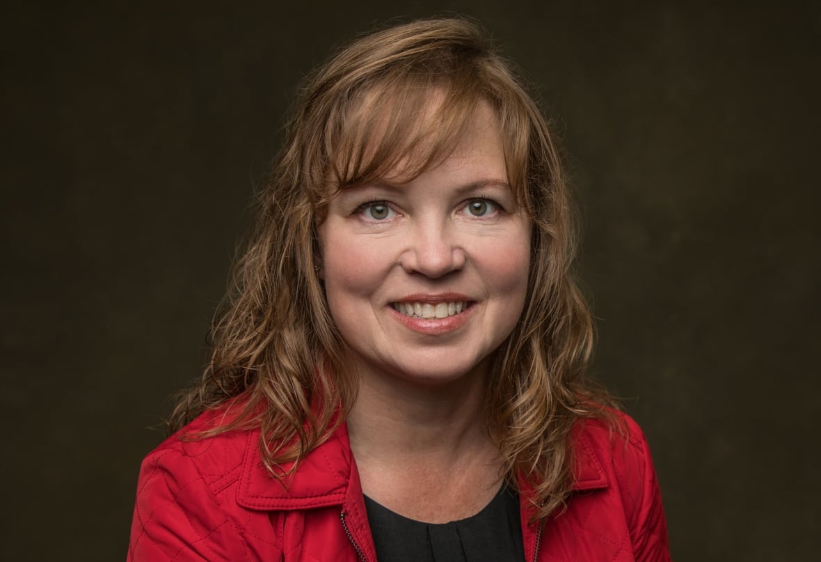 Merle Massie smiles in a professional headshot.