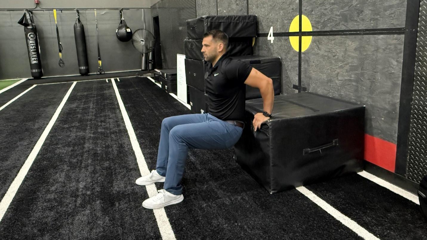 man doing exercise tricep dips in the gym