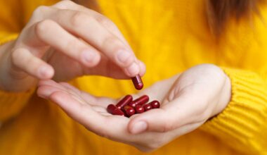 Person holds red vitamins