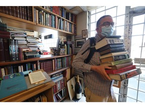 A customer leaves after purchasing an armful of books at John W. Doull Bookseller in Dartmouth on Tuesday, July 22, 2025.