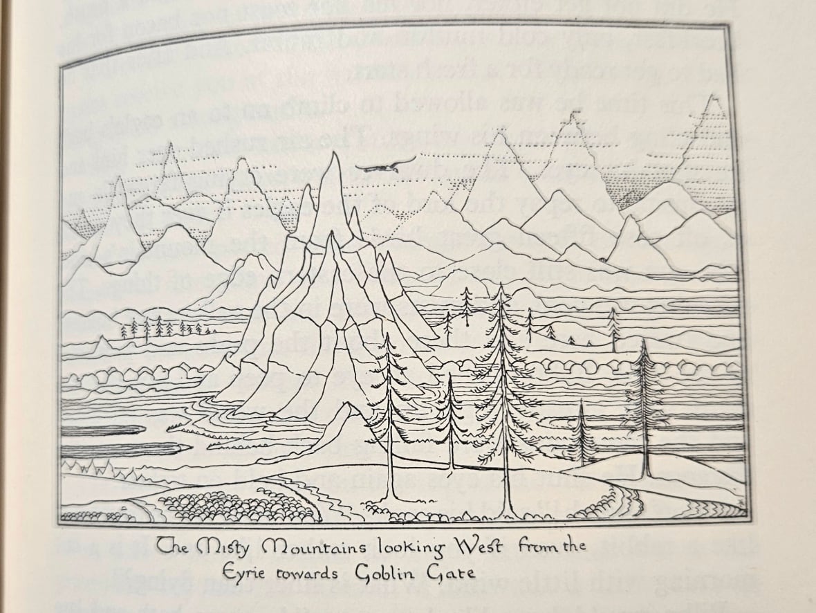 An illustration inside a book of mountains and a forest. 