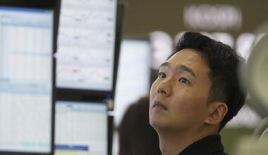 Asian shares are mixed after stocks add a bit to their records on Wall Street