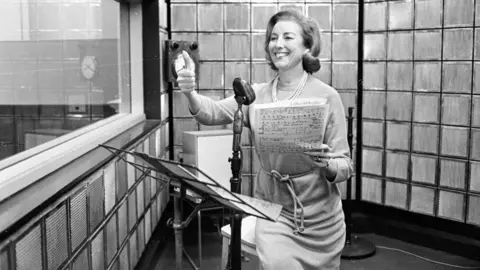 Getty Images A black and white picture of British singer Vera Lynn rehearsing her new radio show