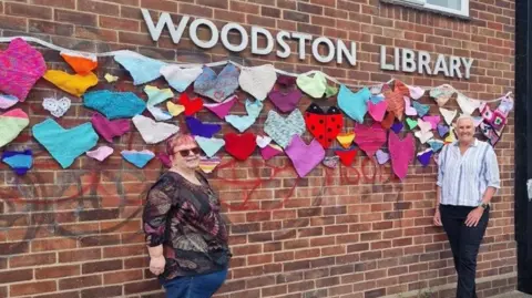 Friends of Woodston Library Volunteers from the Knitter-knatter group held every week at the library knitted hundreds of hearts and covered up the graffiti on the library wall
