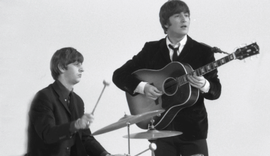 Ringo Starr &amp; John Lennon (playing Gibson J160E acoustic guitar) performing during the filming of "A Hard Day's Night", at the Scala Theatre