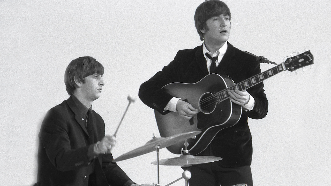 Ringo Starr &amp; John Lennon (playing Gibson J160E acoustic guitar) performing during the filming of "A Hard Day's Night", at the Scala Theatre
