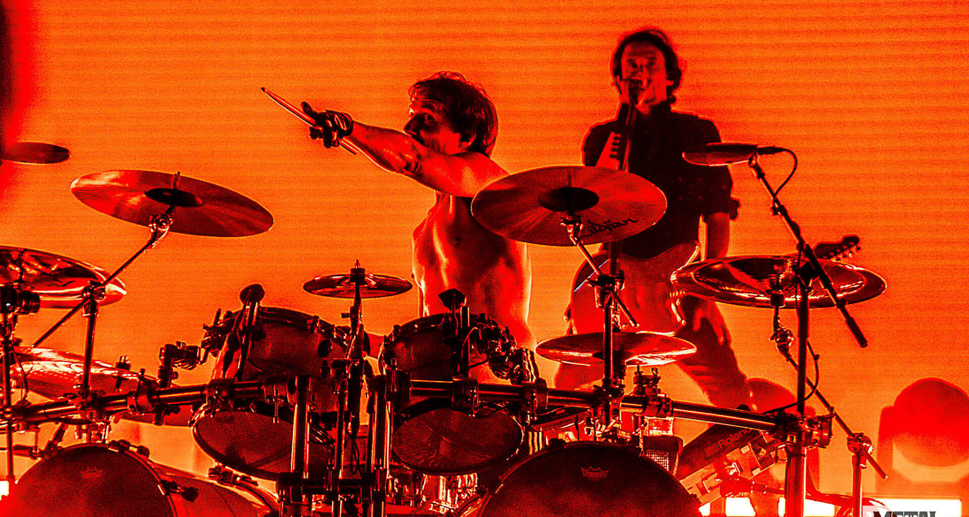 A photo of Mario Duplantier and Joe Duplantier from Gojira live on stage.