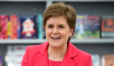 Nicola Sturgeon stands in front of books at a school in Prestwick, Scotland