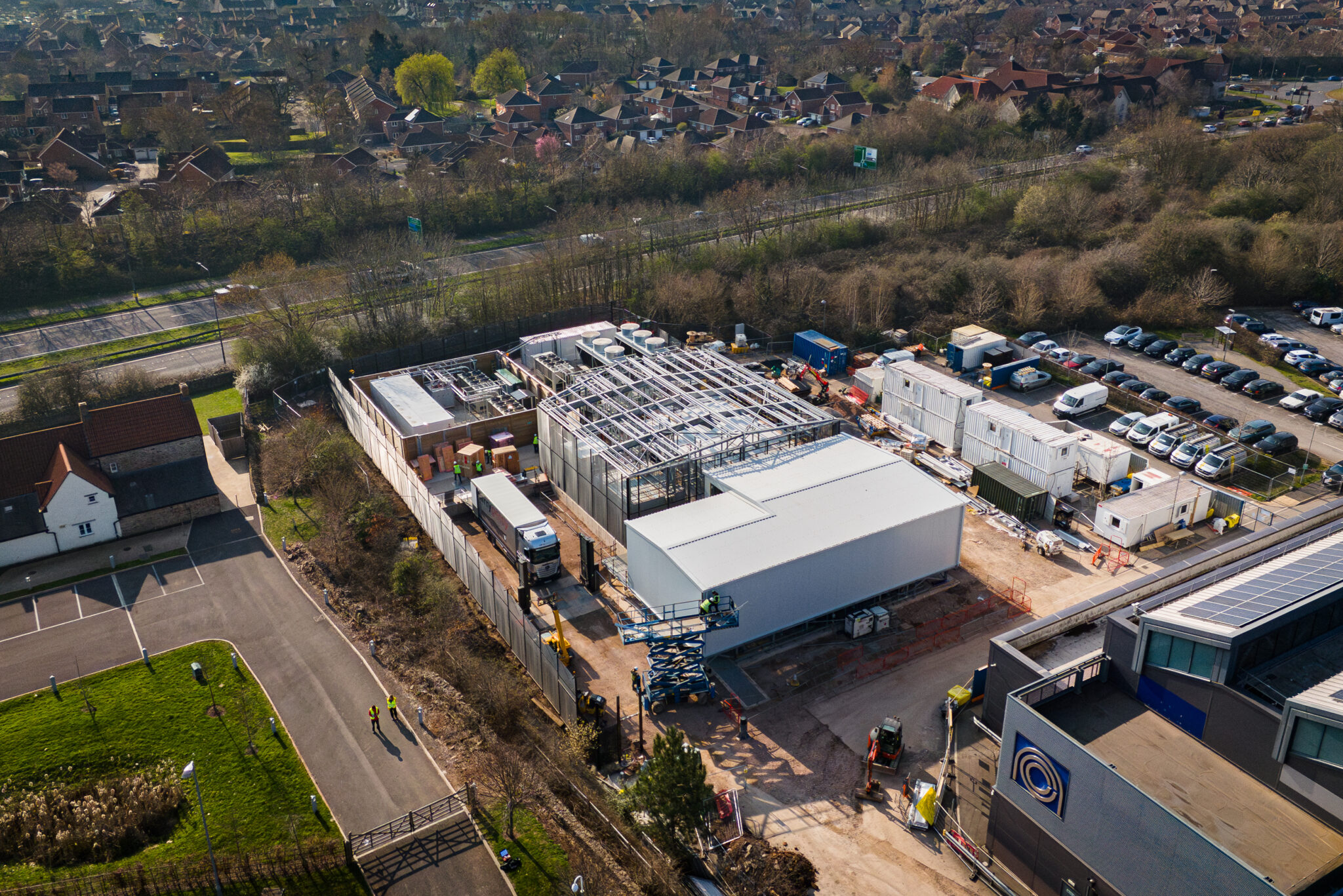 An aerial view of the Isambard-AI construction site, illustrating the scale of the modular data center build and the rapid progress made in creating the U.K.’s most powerful AI supercomputer.