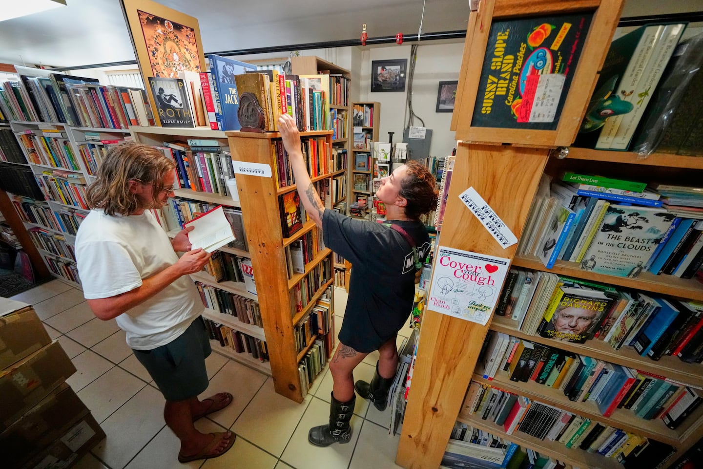 Andrew Higgins and Savannah Shealy perused the biography section of the Green Hand Bookstore in Portland, Maine, on Aug. 7.