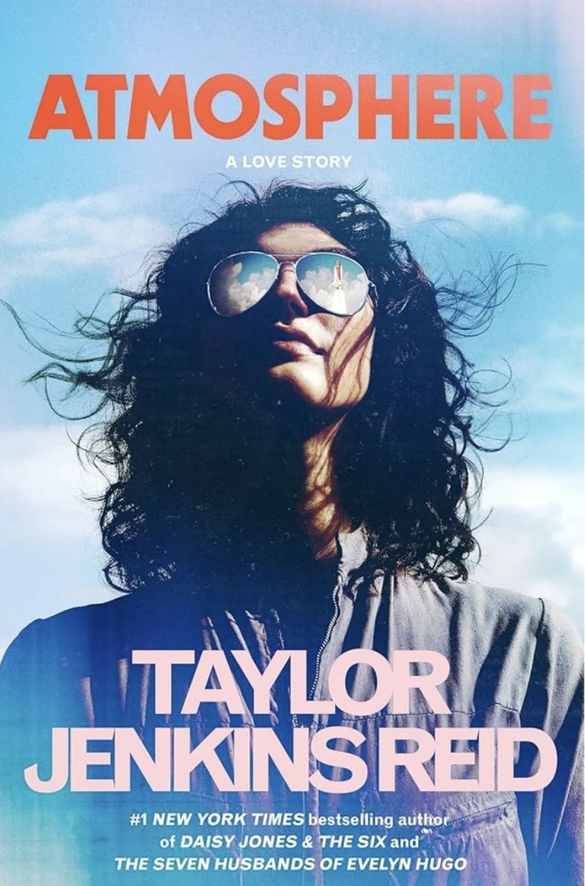 Woman looks up the skies with sunglasses in front of clouds.