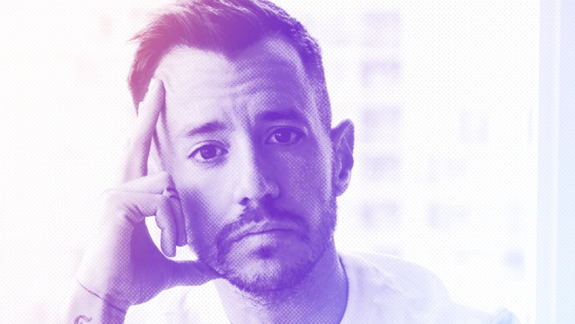 A closeup of a man's face in white, pink and purple halftones.