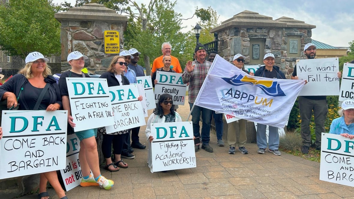 People posing with signs