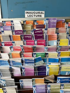 Many brightly coloured pamphlets on a large shelf with a sign reading