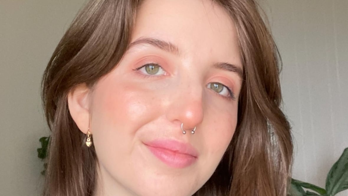 A woman with medium length brown hair smiling at the camera.