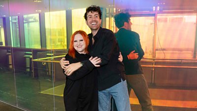 Photo of Nick Grimshaw and Beth Ditto hugging and smiling to camera.