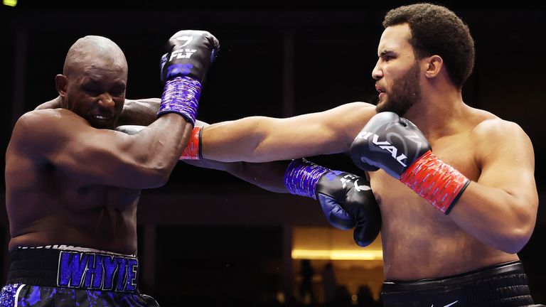 Moses Itauma punches Dillian Whyte during the WBO Inter-Continental Heavyweight title fight