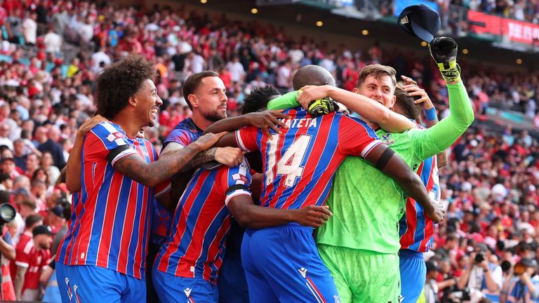 Crystal Palace players mob goalkeeper Dean Henderson after beating Liverpool on penalties to win the Community Shield