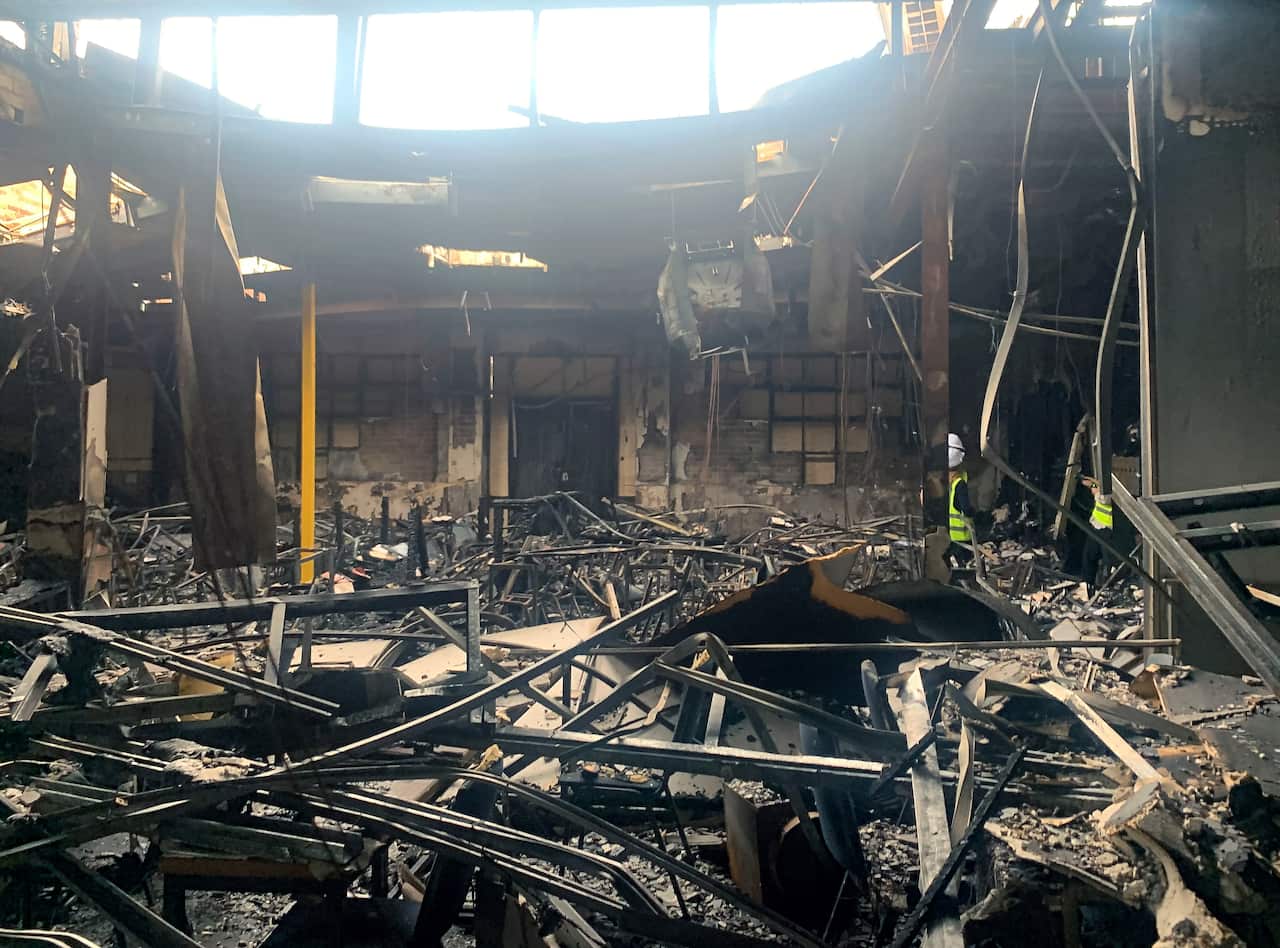 the charred inside of a building that has been badly damaged by fire