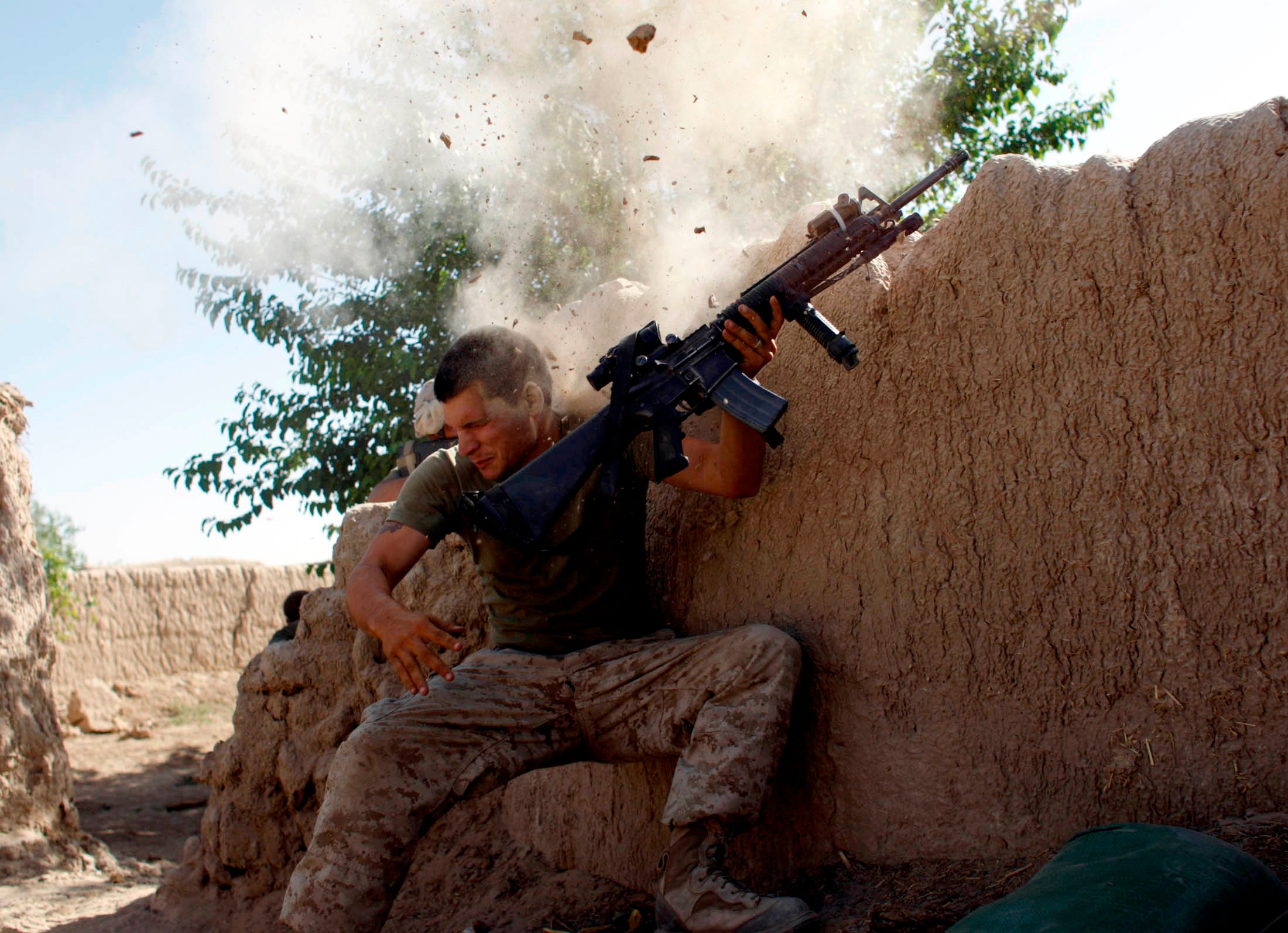 Sgt. William Olas Bee, a U.S. Marine from the 24th Marine Expeditionary Unit, has a close call after Taliban fighters opened fire near Garmser in Helmand Province