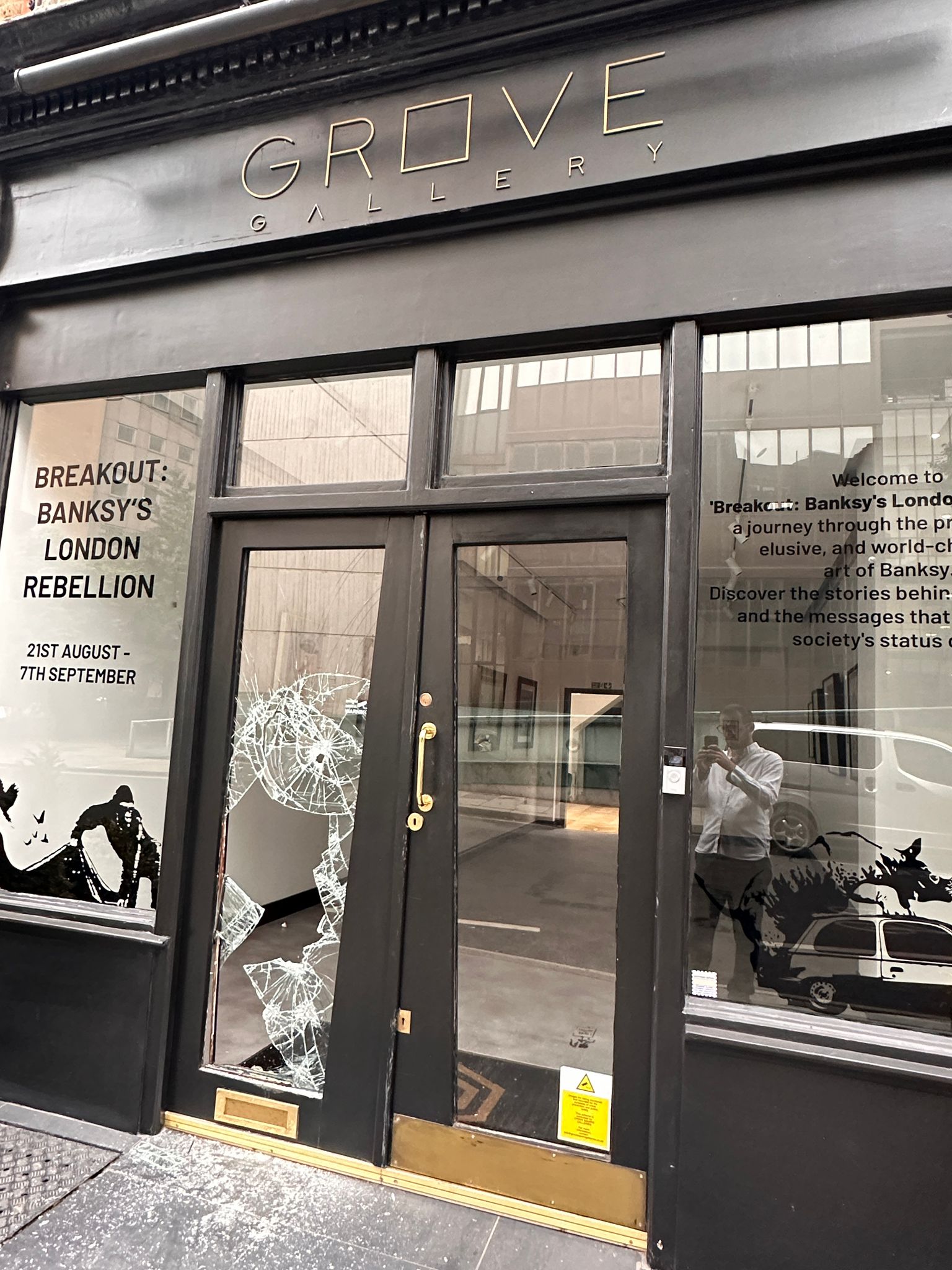 Grove Gallery storefront with broken window after a Banksy print theft.
