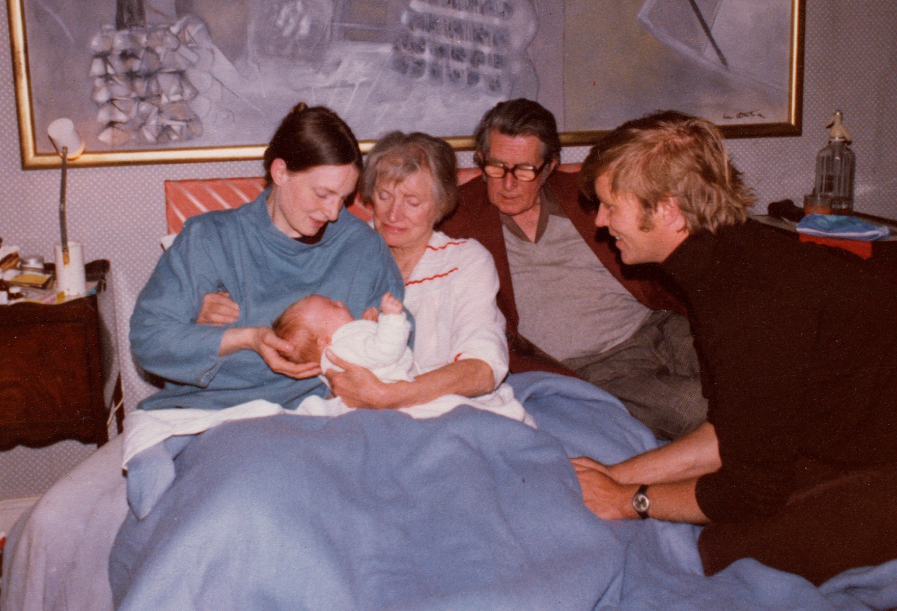 Photo of Suzanna Penrose, Ami Bouhassane, Lee Miller, Roland Penrose, and Antony Penrose in a bedroom with a newborn baby.