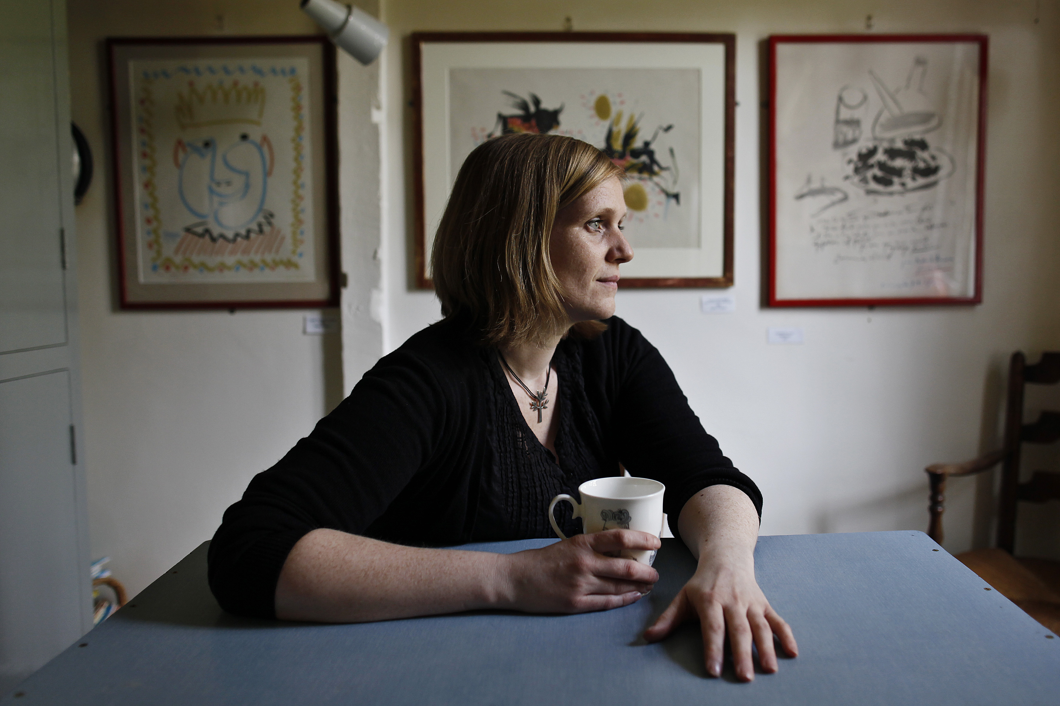 Ami Bouhassane in the kitchen of Farley Farm House, with Picasso paintings in the background.