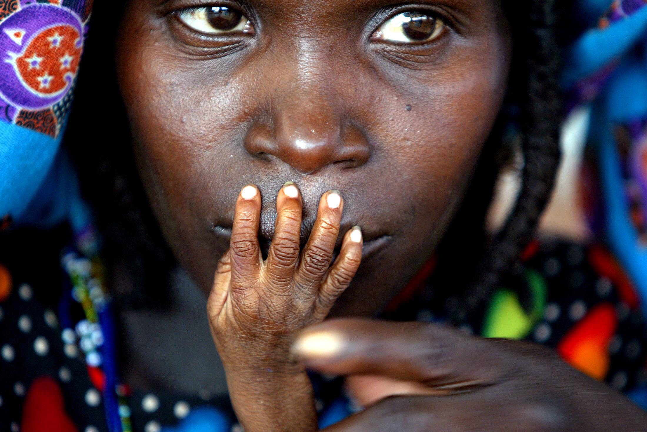 Woman brings child to emergency feeding centre in Niger.