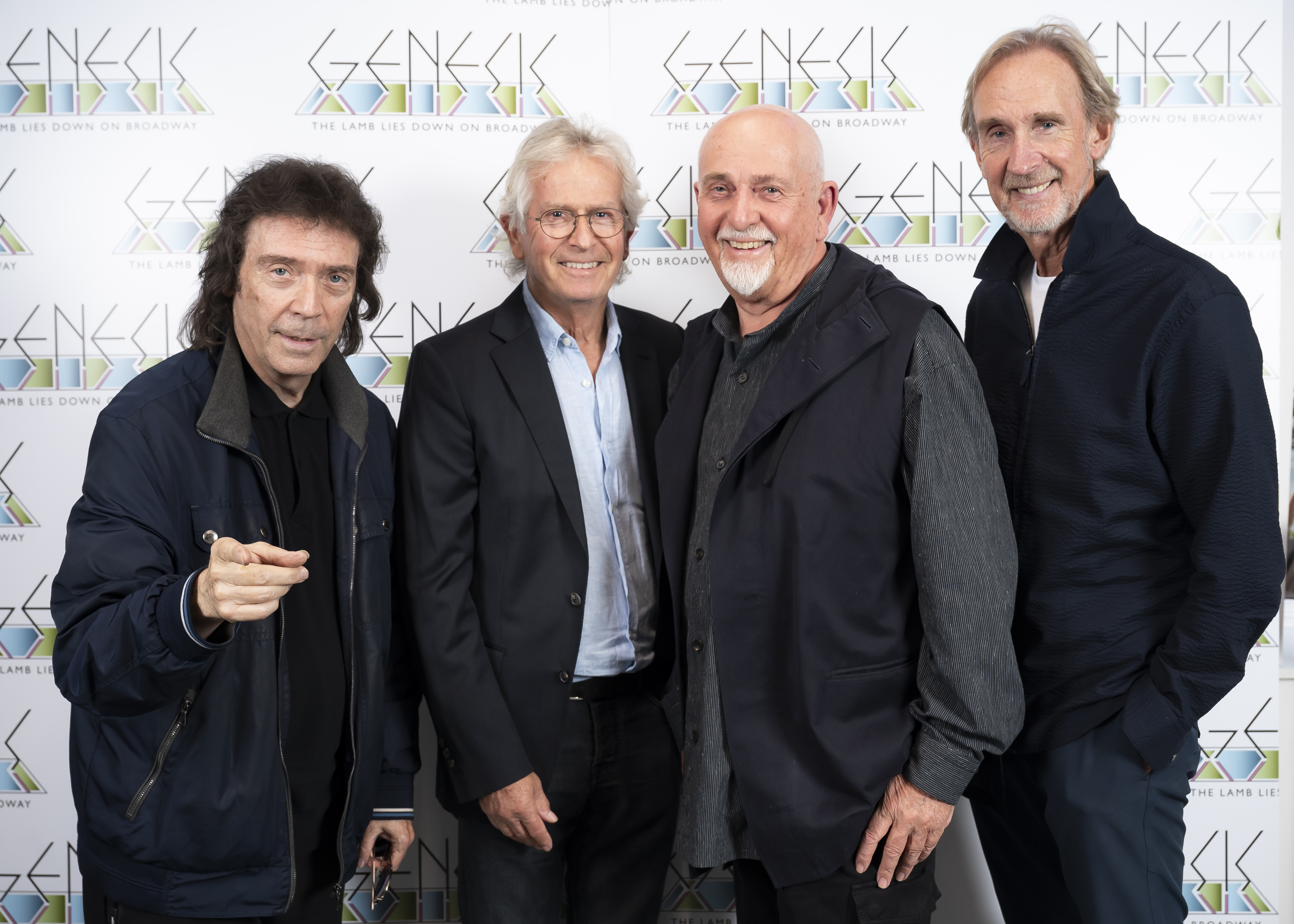 Genesis members Steve Hackett, Tony Banks, Peter Gabriel, and Mike Rutherford posing together.