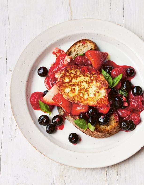 A plate of food with toasted bread, halloumi and berries