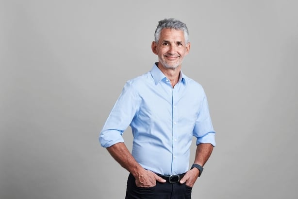 A photo of Tim Spector, wearing a pale blue shirt and smiling