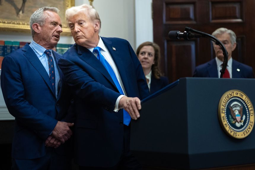 Health and Human Services Secretary Robert F. Kennedy Jr. speaks quietly to President Donald Trump during a news conference at the White House on Monday, in which the President spoke about a alleged link between autism and use the use of acetaminophen by mothers during pregnancy.