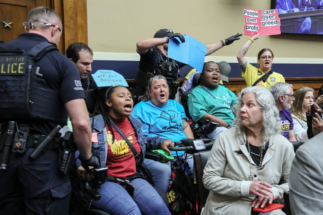 Capitol Police remove a wheel-chair bound protestors from a Energy And Commerce Committee hearing involving buget reconciliation, on May 13.
