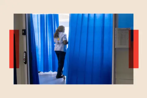 PA Wire A member of staff on a NHS hospital ward