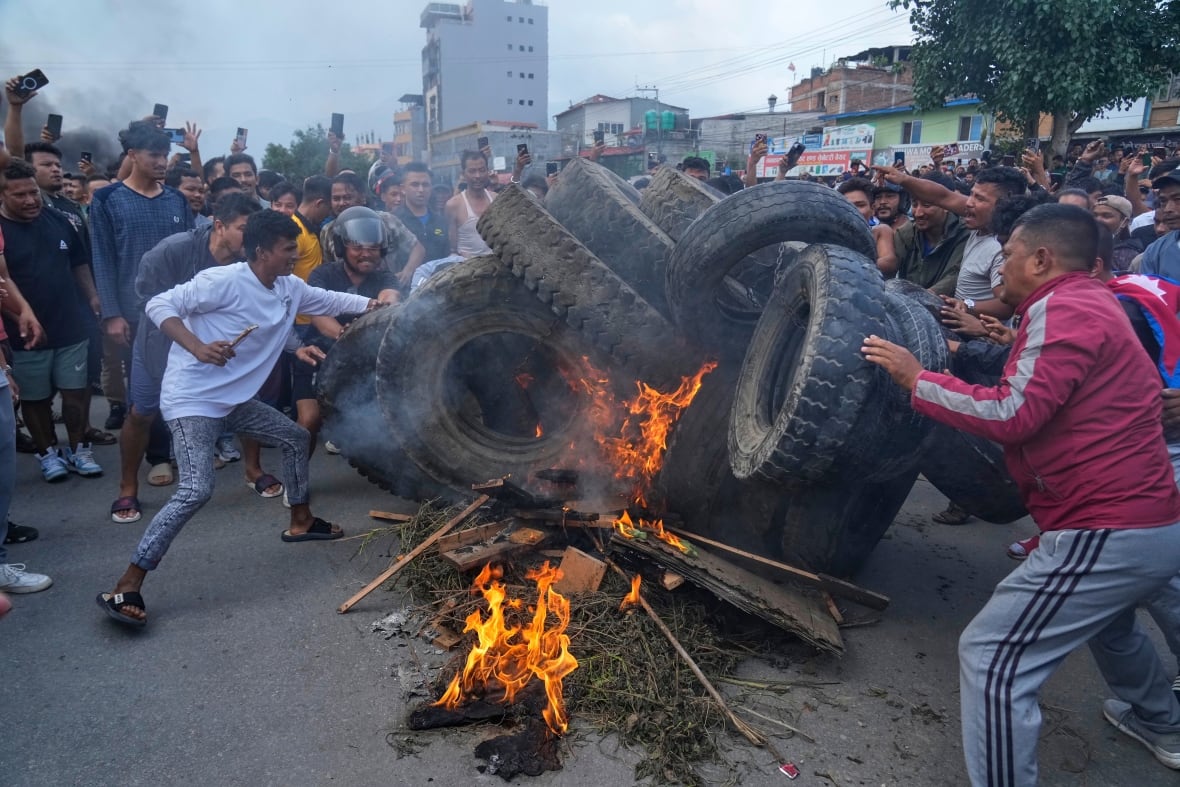 Protesters burn tires in the streets of Nepal.