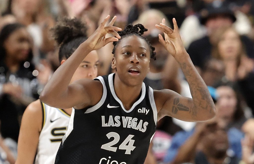 Las Vegas Aces guard Jewell Loyd (24) reacts after scoring a 3-point basket against the Chicago Sky during the second half of a WNBA basketball game Tuesday, Sept. 9, 2025, in Las Vegas. Loyd scored her 6,000th career point during the game. (Steve Marcus/Las Vegas Sun via AP)